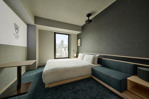 a hotel room with a bed and a couch at The Royal Park Canvas Ginza Corridor in Tokyo