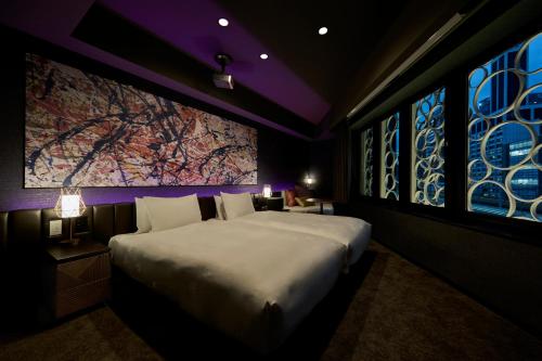 a bedroom with a large bed and a large window at The Royal Park Canvas Ginza Corridor in Tokyo