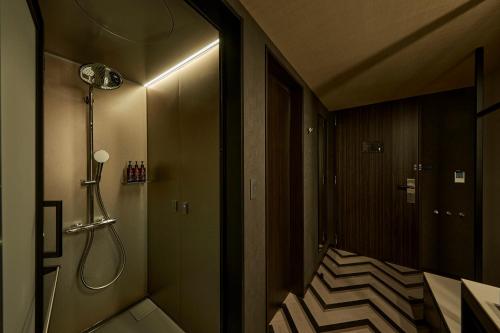 a small bathroom with a shower and a staircase at The Royal Park Canvas Ginza Corridor in Tokyo