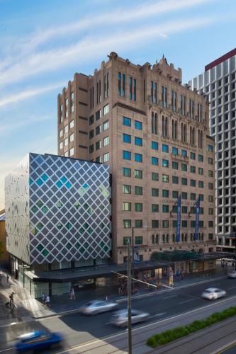 a city with buildings and a street with cars at Mayfair Hotel in Adelaide