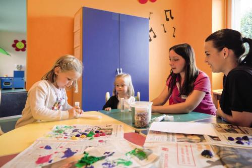 a group of girls sitting at a table making crafts at Belambra Clubs Trégastel - Le Castel Sainte Anne in Trégastel