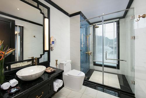 a bathroom with a sink and a toilet and a shower at LaPinta Boutique Cruises in Ha Long