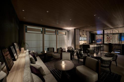 a living room with couches and chairs and tables at The Royal Park Canvas Ginza Corridor in Tokyo