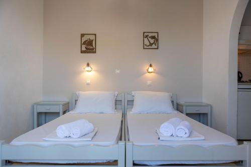 two beds in a room with towels on them at Studios Alsos in Naxos Chora