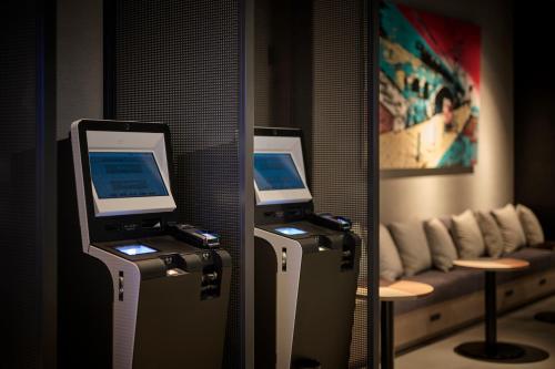 a room with two computer monitors in front of a mirror at The Royal Park Canvas Ginza Corridor in Tokyo