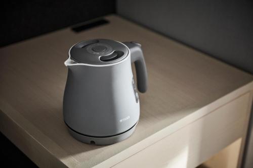 a electric kettle sitting on a counter top at The Royal Park Canvas Ginza Corridor in Tokyo