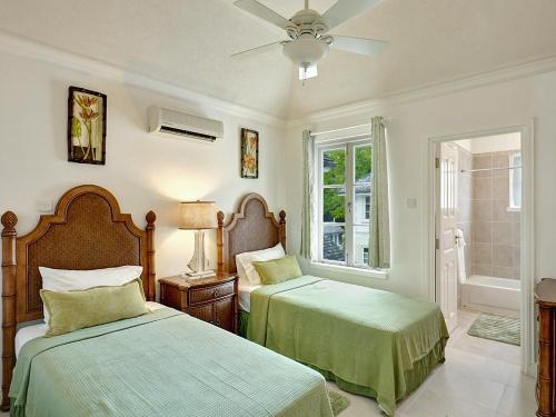 a bedroom with two beds and a window at The Falls Townhouse 10 by BSL Rentals in Saint James