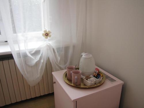 a table with a tray of items on it next to a window at BB La Bella Addormentata e il Principe Calaf in Lucca