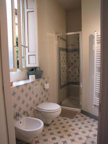 a bathroom with a toilet and a sink and a shower at BB La Bella Addormentata e il Principe Calaf in Lucca