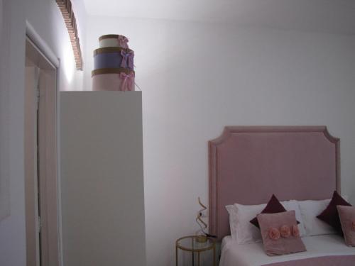 a bedroom with a bed with a headboard at BB La Bella Addormentata e il Principe Calaf in Lucca