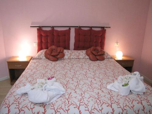 a bedroom with a bed with towels on it at BB La Bella Addormentata e il Principe Calaf in Lucca