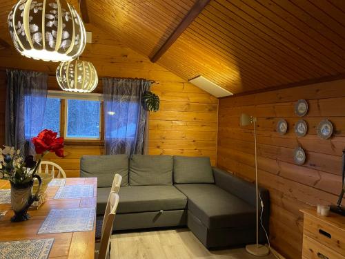 a living room with a couch and a table at Holiday House with beautiful scenery near Göta Kanal in Undenäs
