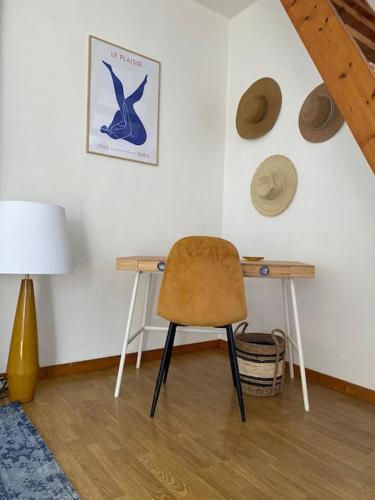 - un bureau dans une chambre avec une chaise et une lampe dans l'établissement Appartement Miramar - Plage 50m - Rue gratuite, à Saint-Malo