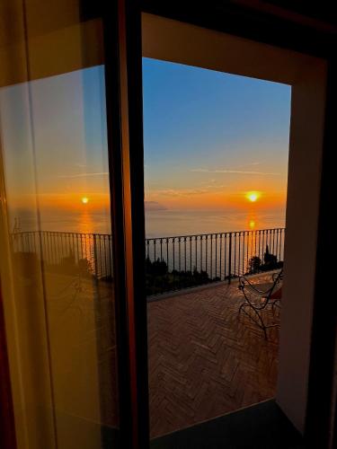 a view of a sunset from a balcony at Villa Alba d'Oro - Historic luxury villa in Amalfi