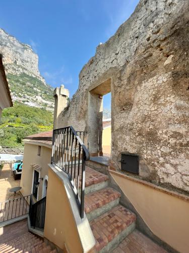a staircase leading up to a building with a wall at Villa Alba d'Oro - Historic luxury villa in Amalfi
