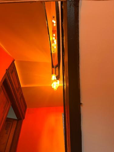 a light hanging from a ceiling in a room at Maison d'hôtes de la prison en toutes libertés in Espalion
