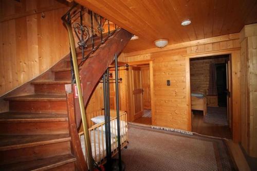 a staircase in a wooden cabin with a stair case at Haus Gerdi in Söll
