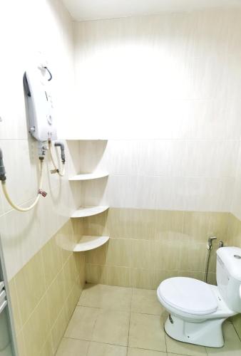 a bathroom with a toilet and a shower with a window at Happy vacation homestay mersing in Mersing
