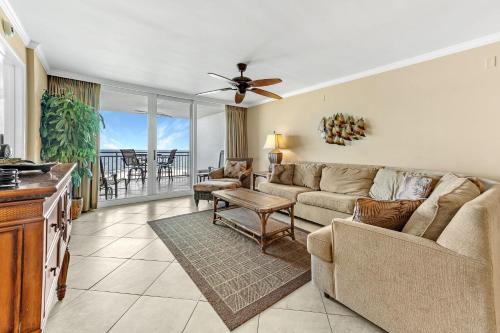 a living room with a couch and a table at SeaSpray East 323- Gulf Front in Perdido Key