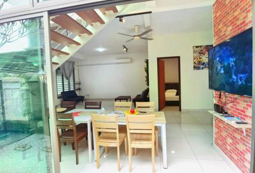a dining room with a table and chairs at 18 Home team family Gathering first choice in Skudai