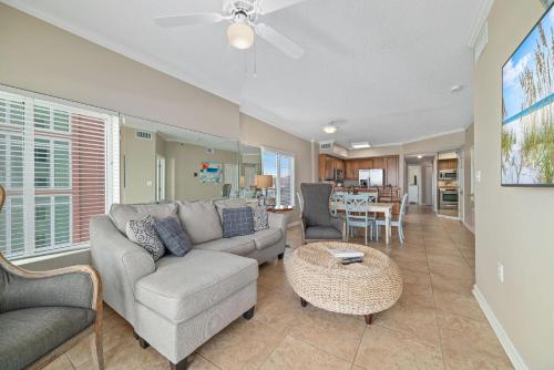 a living room with a couch and a table at Tidewater 609 in Orange Beach