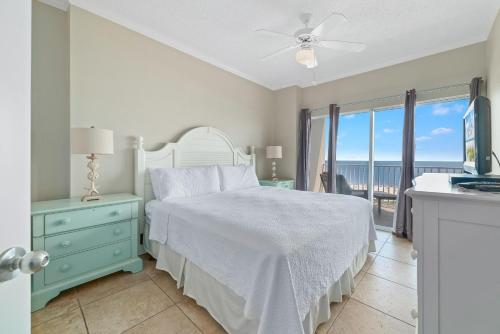 a bedroom with a bed and a view of the ocean at Tidewater 609 in Orange Beach
