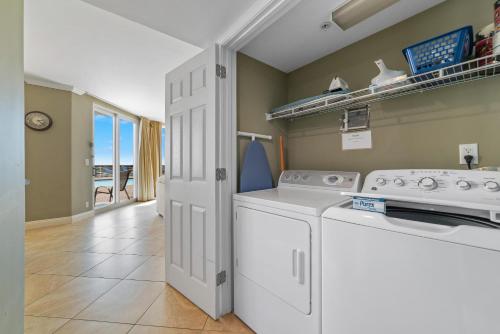 a laundry room with a washer and dryer at SeaSpray West 105- Gulf Front in Perdido Key