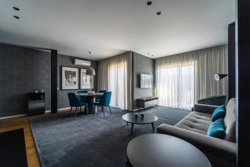 a living room with a couch and a table at Lux Housing Século XXI in Braga