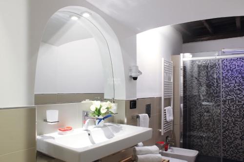 y baño blanco con lavabo y ducha. en Hub Navona, en Roma