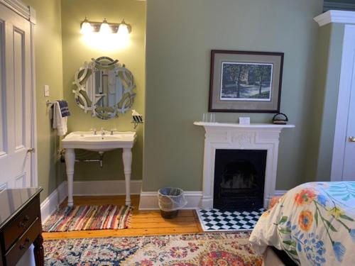 a bathroom with a sink and a fireplace at The Jellybean Heritage Inn in St. John's