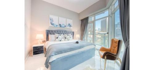 a bedroom with a large bed and a large window at Luxurious 4-Bedroom Duplex VILLA Apartment near JBR in Dubai