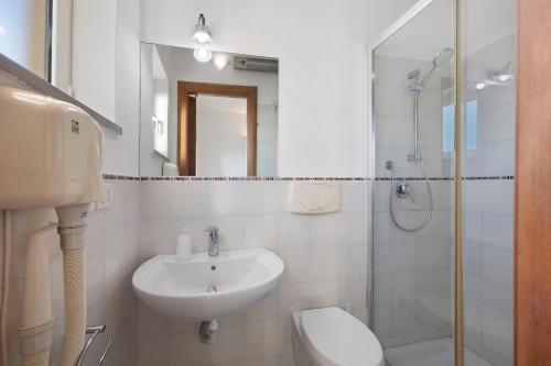 a bathroom with a sink and a toilet and a shower at Casa Santi Appartamento Olivo in Giustenice