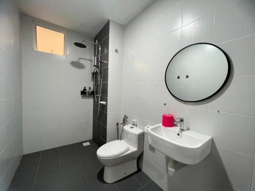 a bathroom with a toilet and a sink and a mirror at NEW!! Loving Night Novo 2BR 4-9pax I Jonker I Netflix I Family in Malacca