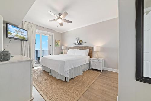 a bedroom with a bed and a television in it at Windemere 1003 in Perdido Key