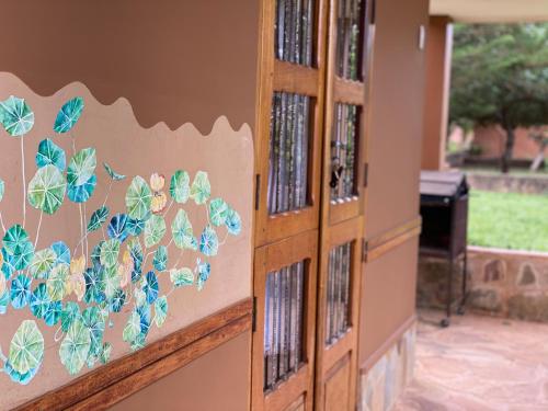 a wall with blue butterflies painted on it at Finca La Vispera in Samaipata