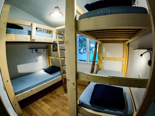 a group of bunk beds in a room at Oleron Surf House in Allards