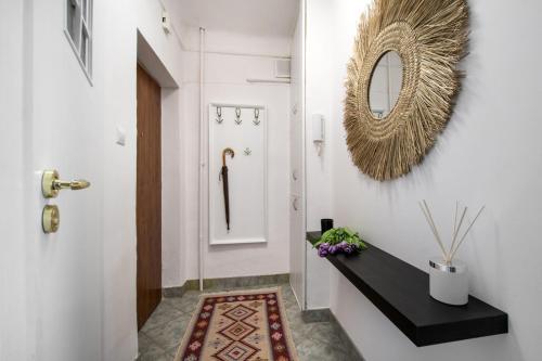 a hallway with a black bench and a mirror at Parrot Dream.Stunning 2 bedrooms near metro&center in Warsaw