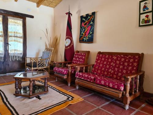a living room with a couch and two chairs at Hostería La Enramada in Seclantás