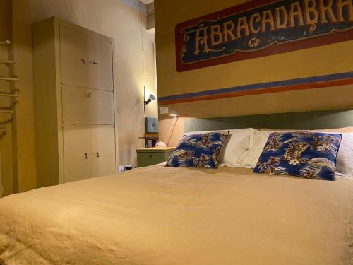 a bedroom with a large bed with blue and white pillows at Circusville in Bologna