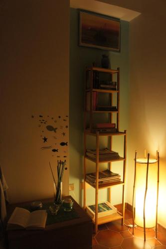 a living room with a book shelf and a table at BlueMind in Tropea