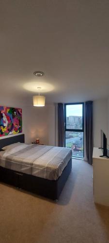 a bedroom with a large bed and a large window at Chavasse Apartments L15DX in Liverpool
