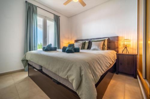 a bedroom with a large bed with a large window at Casa verde in Roldán