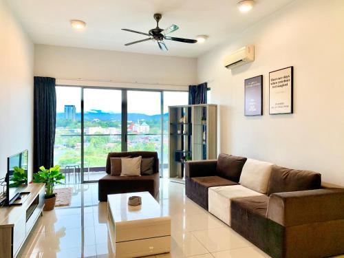 a living room with a couch and a ceiling fan at Deco Home @ Imago The Loft in Kota Kinabalu