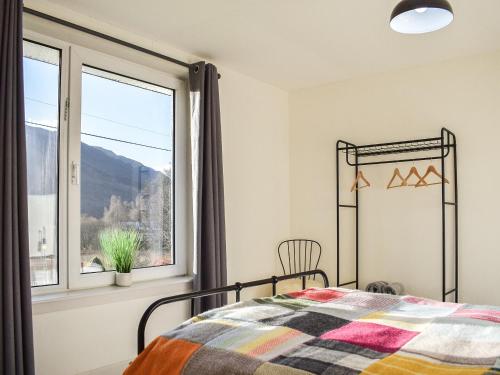 a bedroom with a bed and a window at Ardmhor in Balquhidder