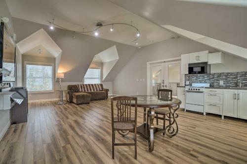 a kitchen and living room with a table and chairs at Pasco Condo with Columbia River Views and Hot Tub in Pasco