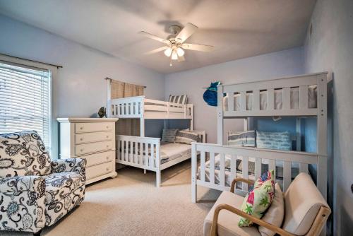 a baby room with two bunk beds and a chair at Oceanfront Oasis in Cedar Key with 2 Balconies! in Cedar Key
