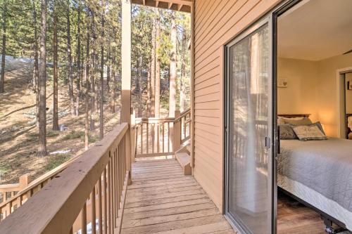 a bedroom with a bed and a balcony with a view of trees at Cozy Incline Village Condo Less Than 3 Mi to Lake Tahoe! in Incline Village