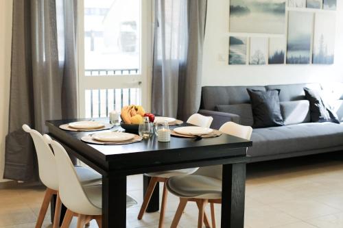 a black dining table with chairs and a couch at Beautiful Apartment - Ben Yehuda - City Center in Jerusalem