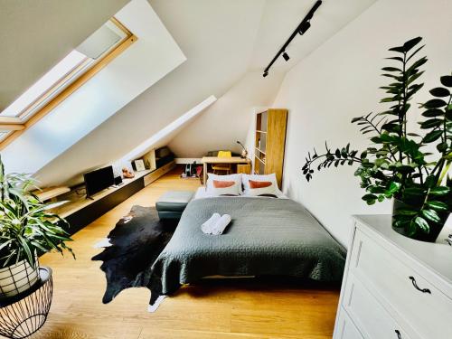 a bedroom with a bed in a attic at BL - The Penthouse, 24hr Self Check-in, 2 Bedrooms, Fireplace, AC, Panoramic View from main Balcony, 3-minute walk to City Center in Banská Bystrica