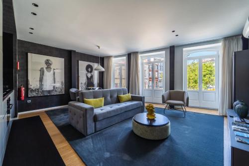 a living room with a couch and a table at Lux Housing Século XXI in Braga